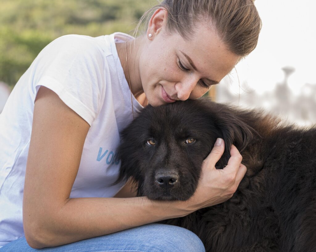 woman-petting-fluffy-black-dog-outdoors